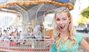 Happy young woman in sunglasses eating ice cream