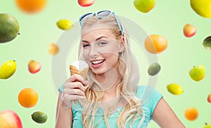 Happy young woman in sunglasses eating ice cream