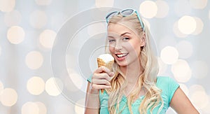 Happy young woman in sunglasses eating ice cream