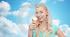 Happy young woman in sunglasses eating ice cream