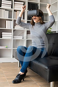 Happy young woman surprised in VR headset, feeling air. Smiling caucasian woman wearing vr glasses,