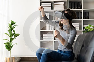 Happy young woman surprised in VR headset, feeling air. Smiling caucasian woman wearing vr glasses,