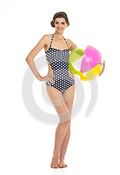 Happy young woman in swimsuit with beach