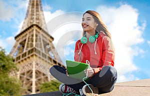 Happy young woman with tablet pc and headphones