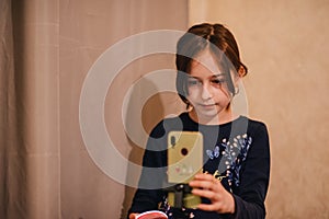 Happy young woman taking selfie on white background. Girl takes a video of herself with a monopod or selfie stick