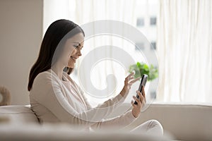 Happy young woman talk on video call on cell