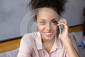 Happy young woman talking on cell phone