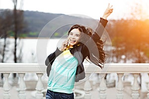 Happy young woman talking on mobile phone