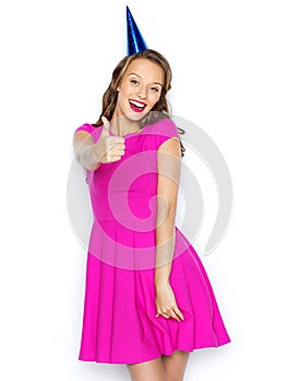 Happy young woman or teen girl in party cap