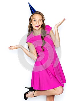 Happy young woman or teen girl in party cap