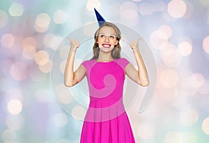 Happy young woman or teen girl in party cap