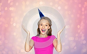 Happy young woman or teen girl in party cap