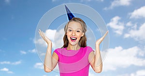 Happy young woman or teen girl in party cap