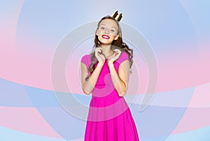 Happy young woman or teen girl in pink dress