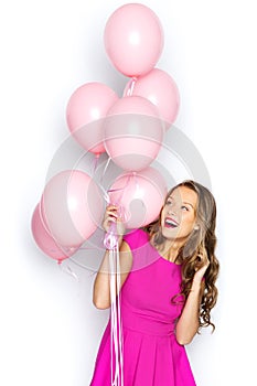 Happy young woman or teen girl in pink dress