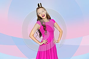 Happy young woman or teen girl in pink dress