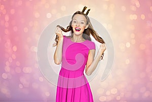 Happy young woman or teen girl in princess crown