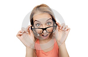 Happy young woman or teenage girl in eyeglasses