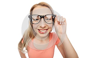 Happy young woman or teenage girl in eyeglasses