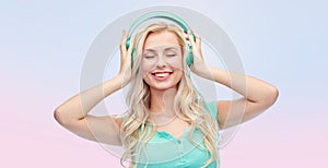 Happy young woman or teenage girl with headphones