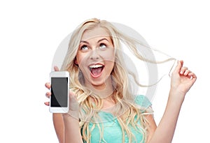 Happy young woman or teenage girl with smartphone