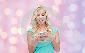 Happy young woman or teenage girl with smartphone
