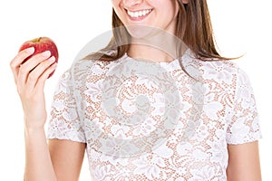 Happy young woman in temptation with red apple in hand