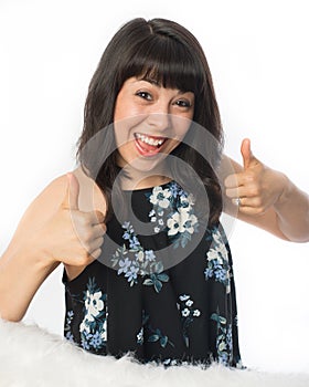 Happy young woman with thumbs up