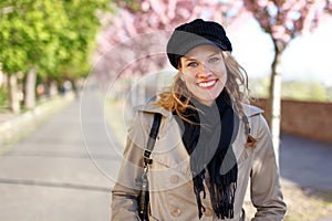 Happy young woman toothy smile at early spring photo