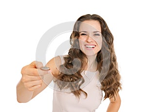 Happy young woman tossing coin