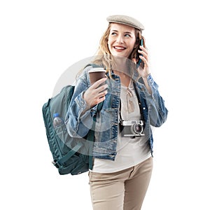 Happy young woman tourist traveler with smartphone, holding paper cup and drinking coffee, wearing a backpack on shoulders,