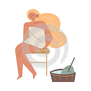 Happy young woman in towel sitting on stool enjoying sauna
