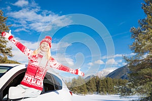 Happy woman travel by car in winter