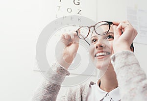 Happy woman trying her new glasses photo