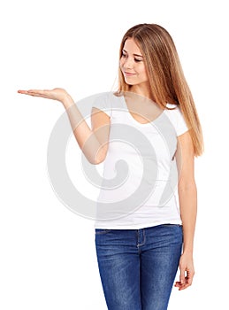 Happy young woman in tshirt showing empty copyspace