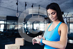 Happy young woman using activity tracker