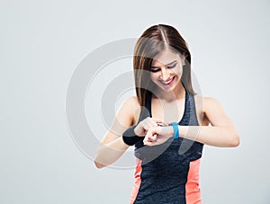Happy young woman using activity tracker