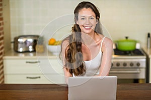 Happy young woman using laptop