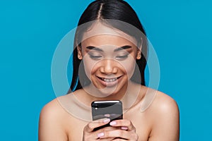 Happy young woman using mobile phone