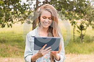 Happy young woman using tablet pc
