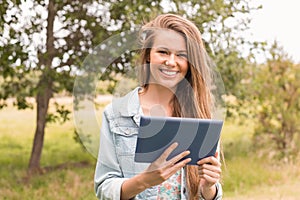Happy young woman using tablet pc