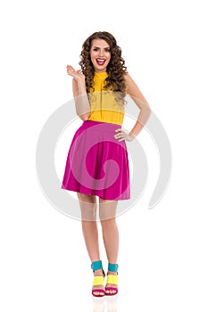 Happy Young Woman In Vibrant Clothes Is Holding Hand Riased And Talking