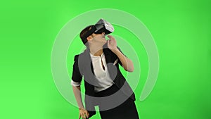 Happy young woman with virtual reality headset or 3d glasses. Green screen