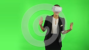 Happy young woman with virtual reality headset or 3d glasses. Green screen