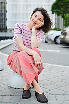 Happy young woman walking confident girl walks outdoors in street smiling