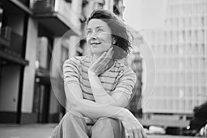 Happy young woman walking confident girl walks outdoors in street smiling