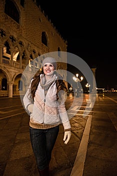 Happy young woman walking near Dogi Palace St. in Venice photo
