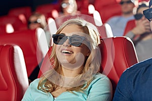 Happy young woman watching movie in theater
