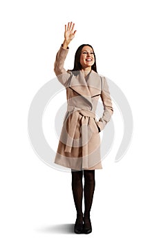 Happy young woman waving hand