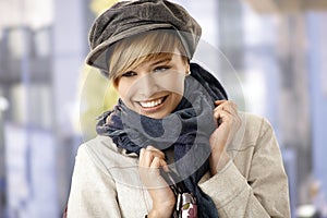 Happy young woman wearing scarf and hat